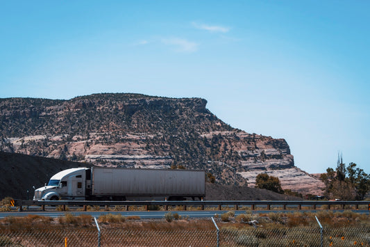 gray and white train on rail near mountain during daytime