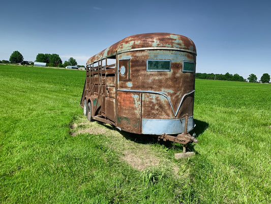 a rusty bus in a field