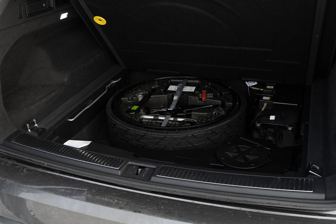 Spare tire and tools in car trunk