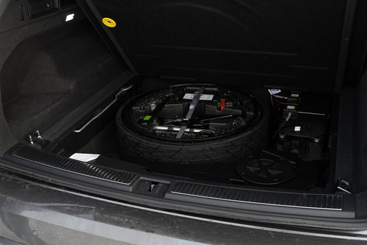 Spare tire and tools in car trunk